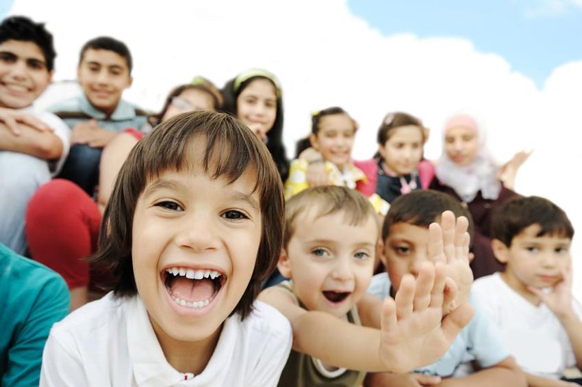 Crowd of children, sitting together happily